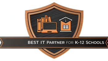 Best IT Partner badge for K-12 schools, featuring a shield design with icons of books, a computer, and a schoolhouse representing comprehensive IT solutions.