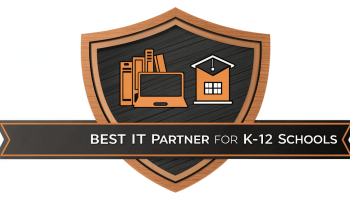 Best IT Partner badge for K-12 schools, featuring a shield design with icons of books, a computer, and a schoolhouse representing comprehensive IT solutions.